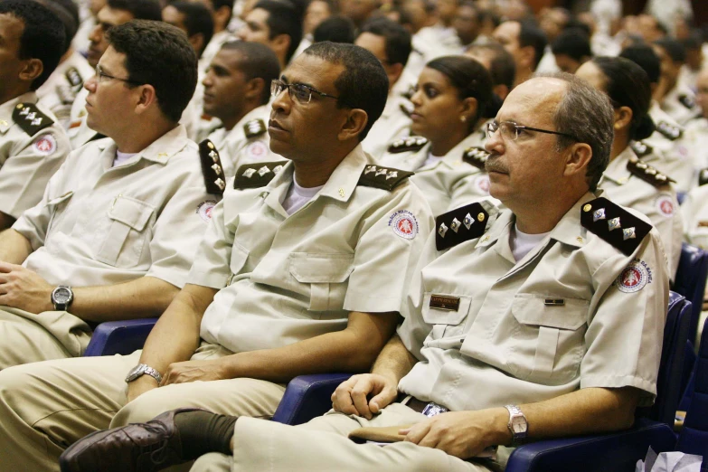 people sitting in a group wearing military uniforms