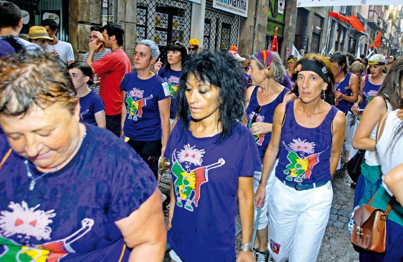 a large group of people with many purple shirts on