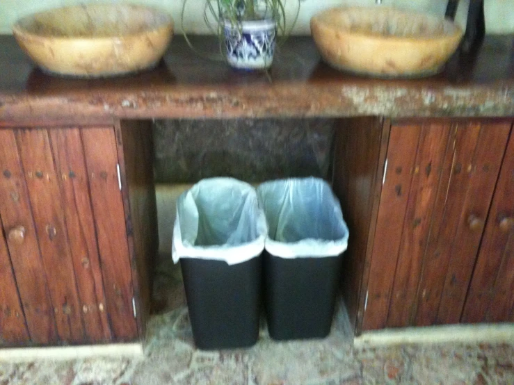 a pair of shoes are standing on a wooden vanity