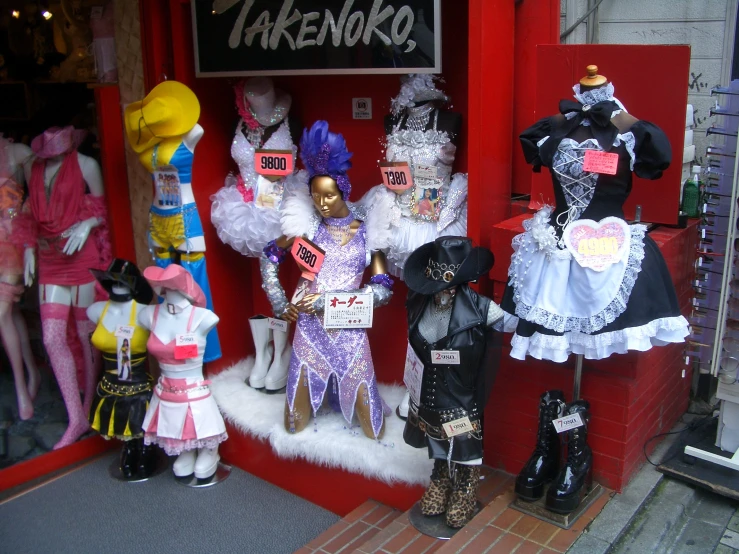 the group of mannequins are outside the store window