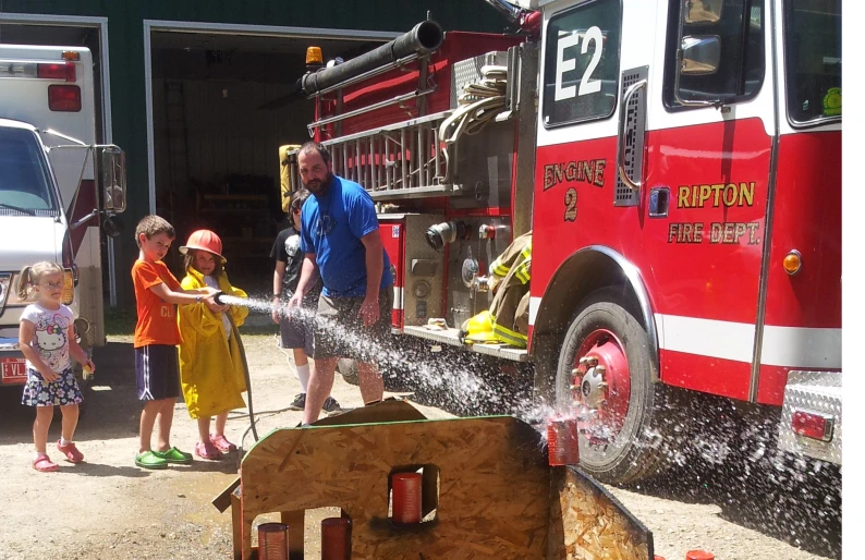 a family getting water from a fire truck