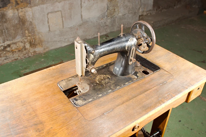 an old sewing machine on a wooden table