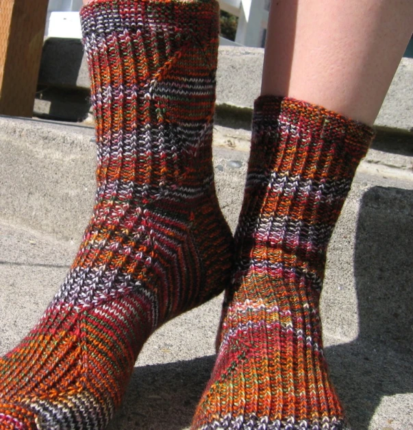 the legs of a person wearing bright socks