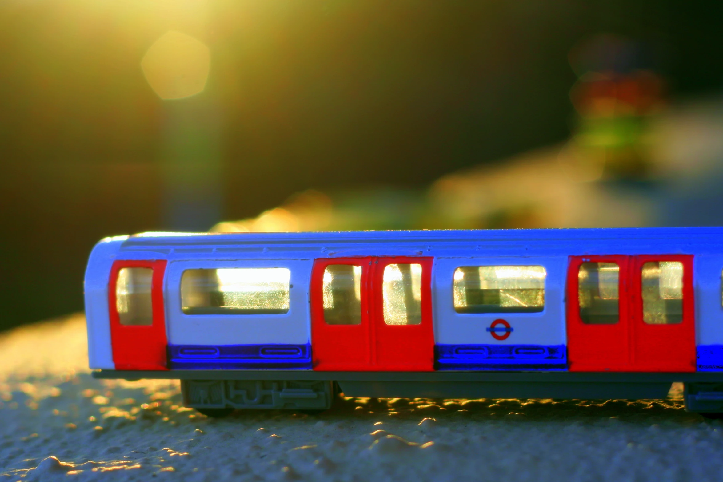 toy train cars on the tracks near trees