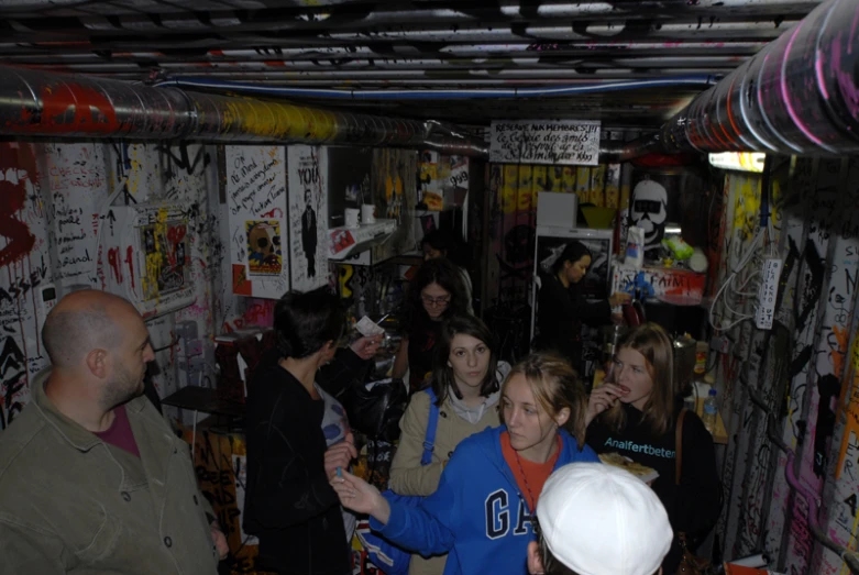 a group of people looking at wall decorations