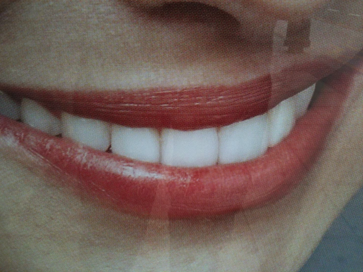 close up of a white mouth smiling with red lips