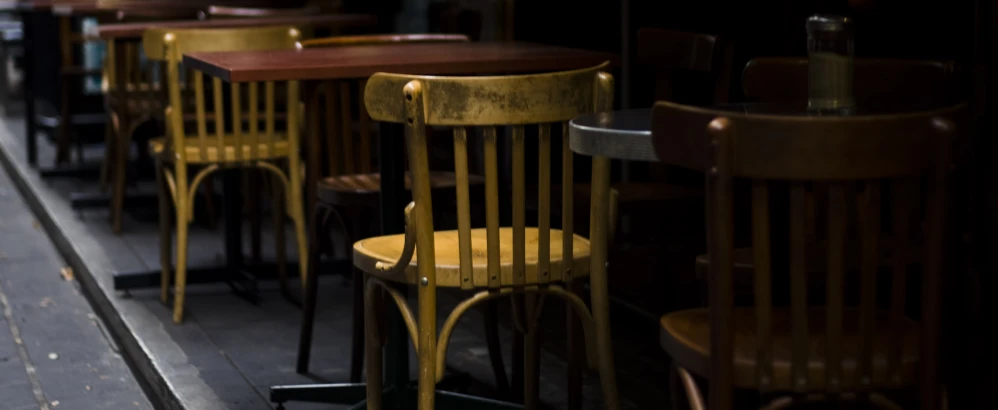 some wooden chairs that are sitting side by side