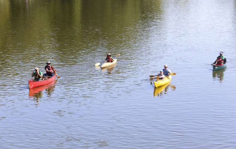 people paddling canoes and canoeing on the water