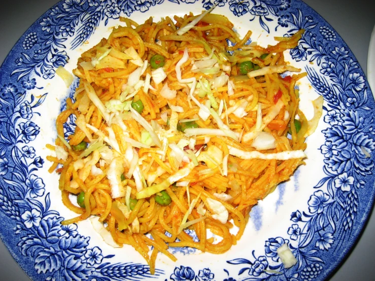 a plate full of asian noodles with cheese