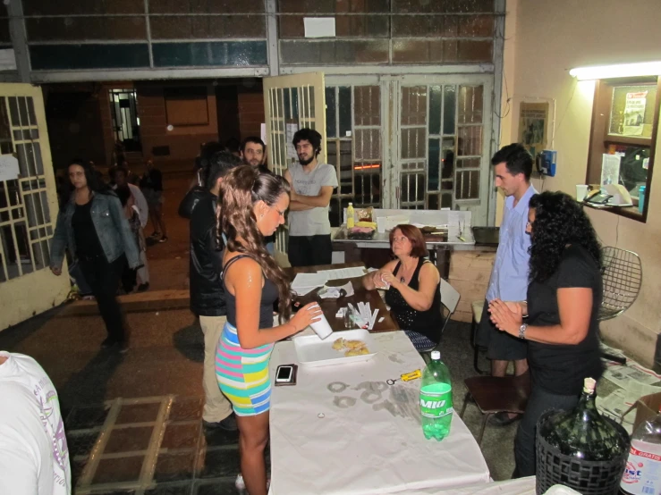 many people having food and drinks at a party