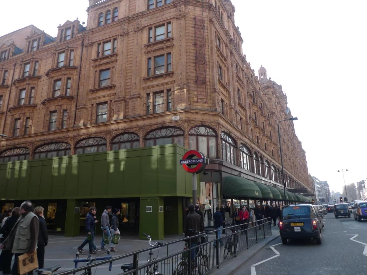 an old street corner in london with buildings and a bus stop