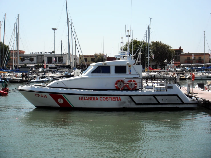 a fishing boat sitting in the water near some docks