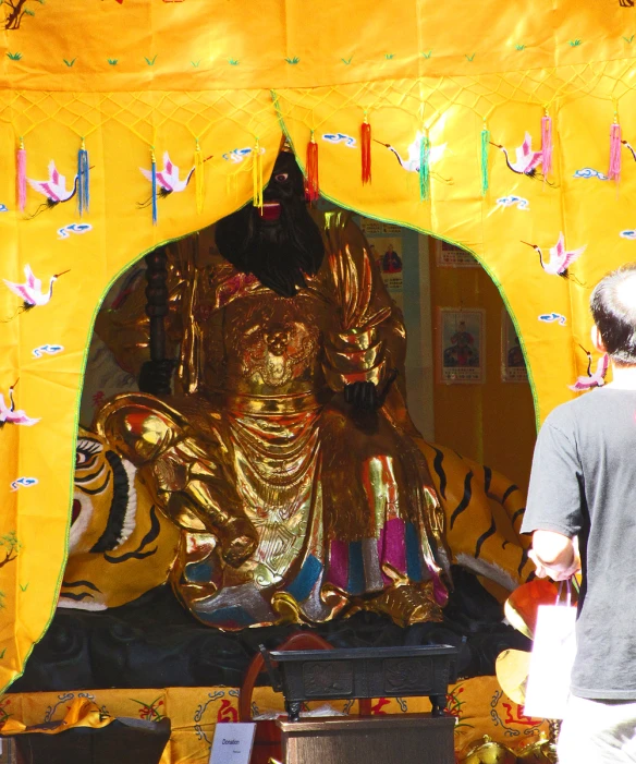 a large golden buddha statue sitting in the center of a group