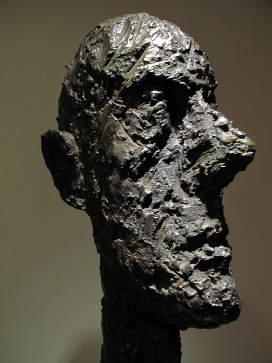 a black sculpture of a man is standing up