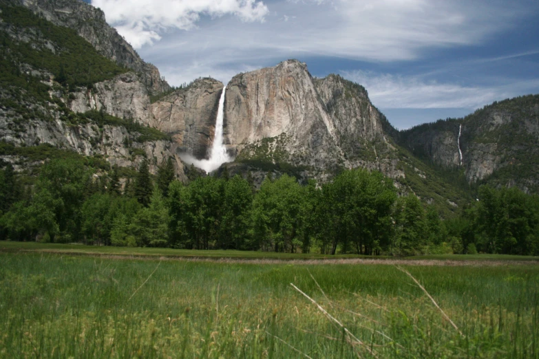 a tall waterfall towering over a lush green forest