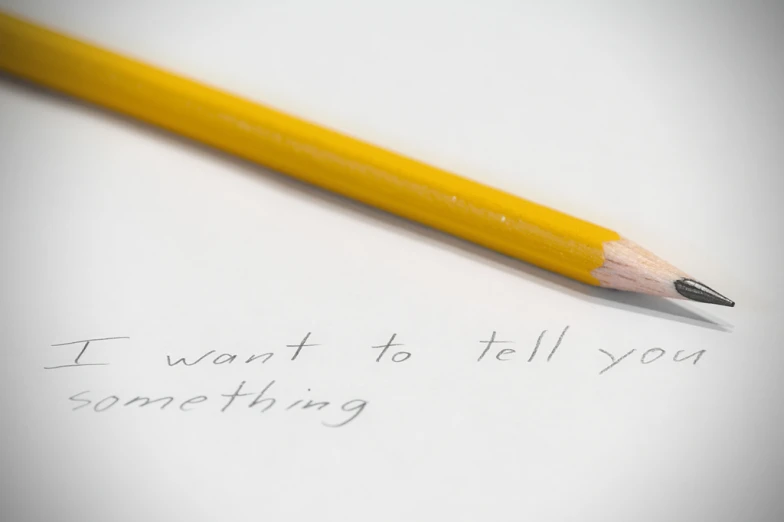 a close up of a pencil writing on a piece of paper