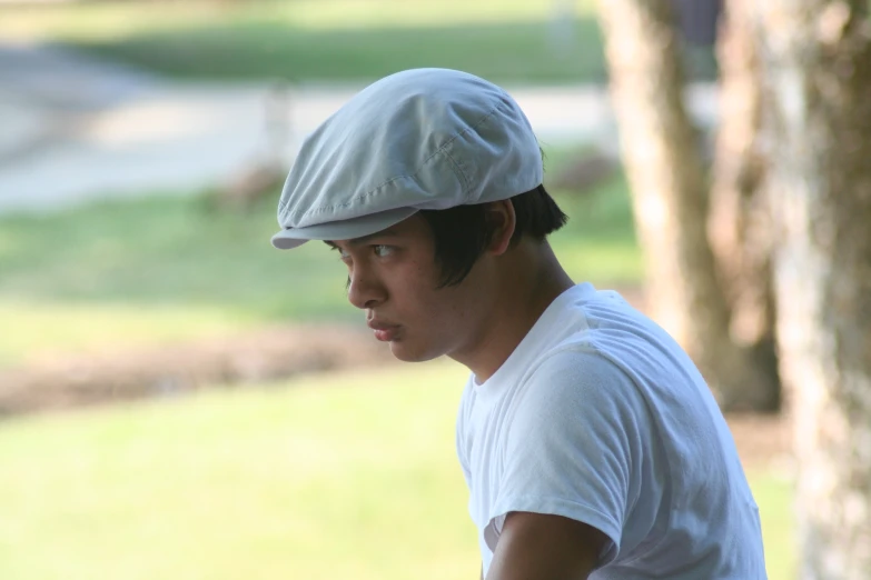 a man wearing a baseball cap looking to his left