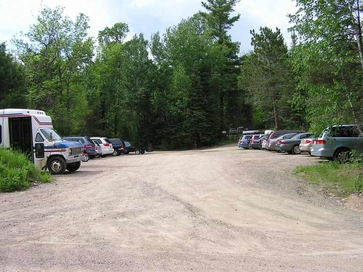 a row of parked vehicles on a dirt road