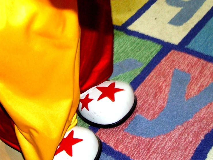 a colorful pair of white shoes on a floor