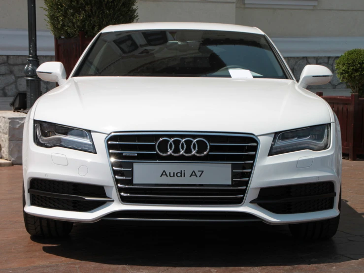 white and black audi car parked in the driveway