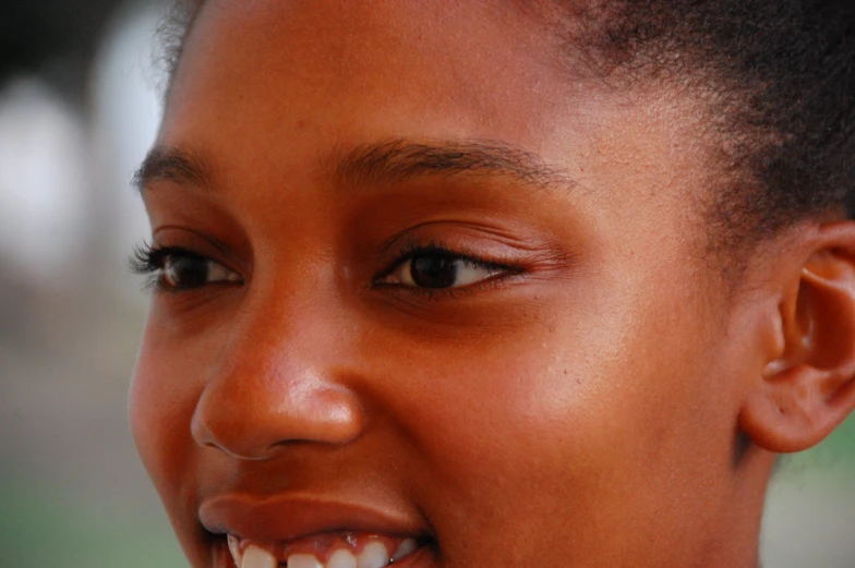 close up of a young woman smiling with black hair