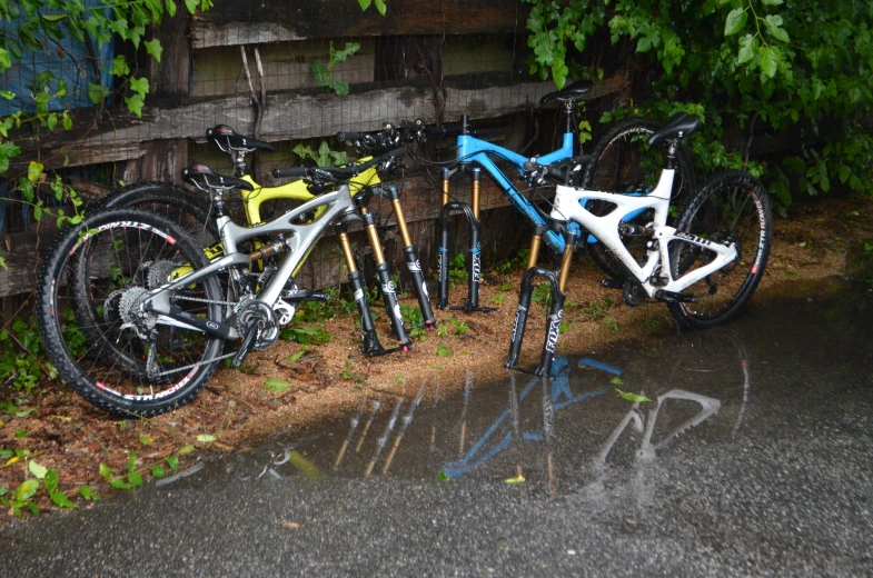 a close up of three bicycles near some trees