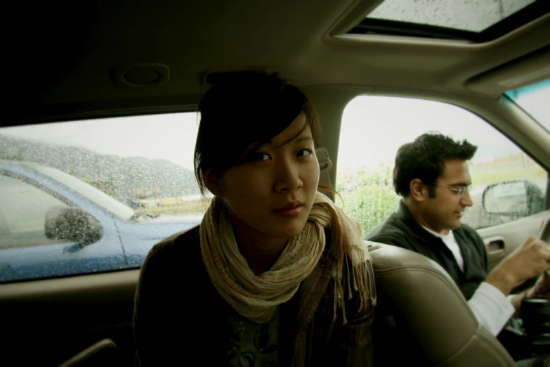 a couple sitting in the back seat of a car