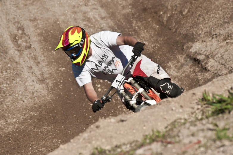 a guy on a bicycle doing tricks on a hill