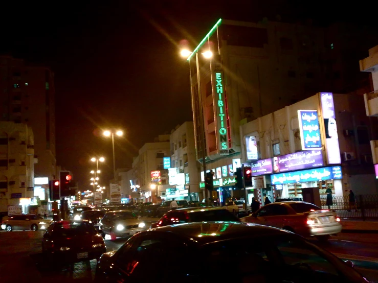 city street lit up with bright neon lights at night