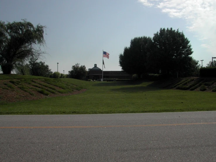 an empty park with a flag on a pole