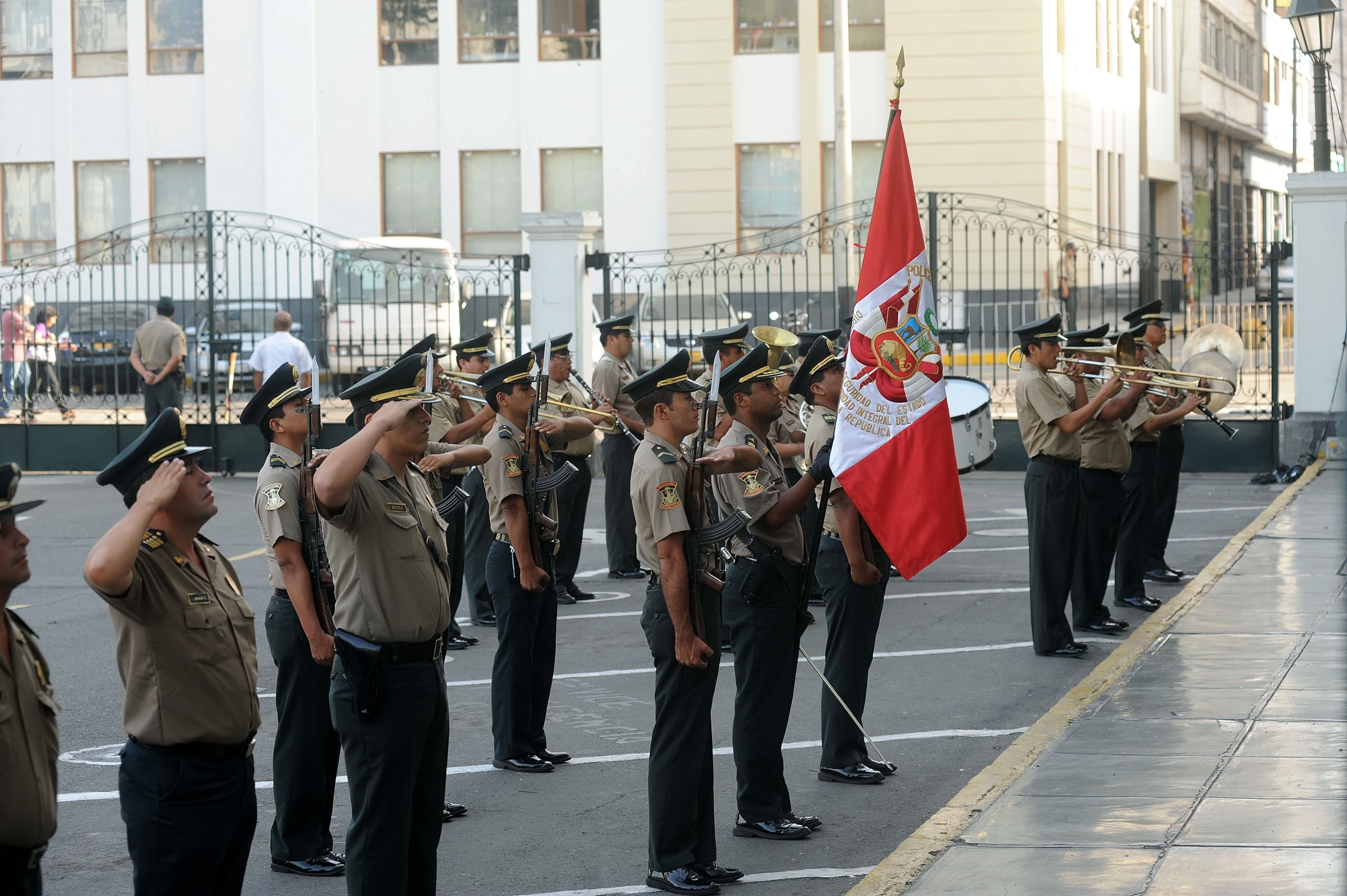 military people marching in front of a building