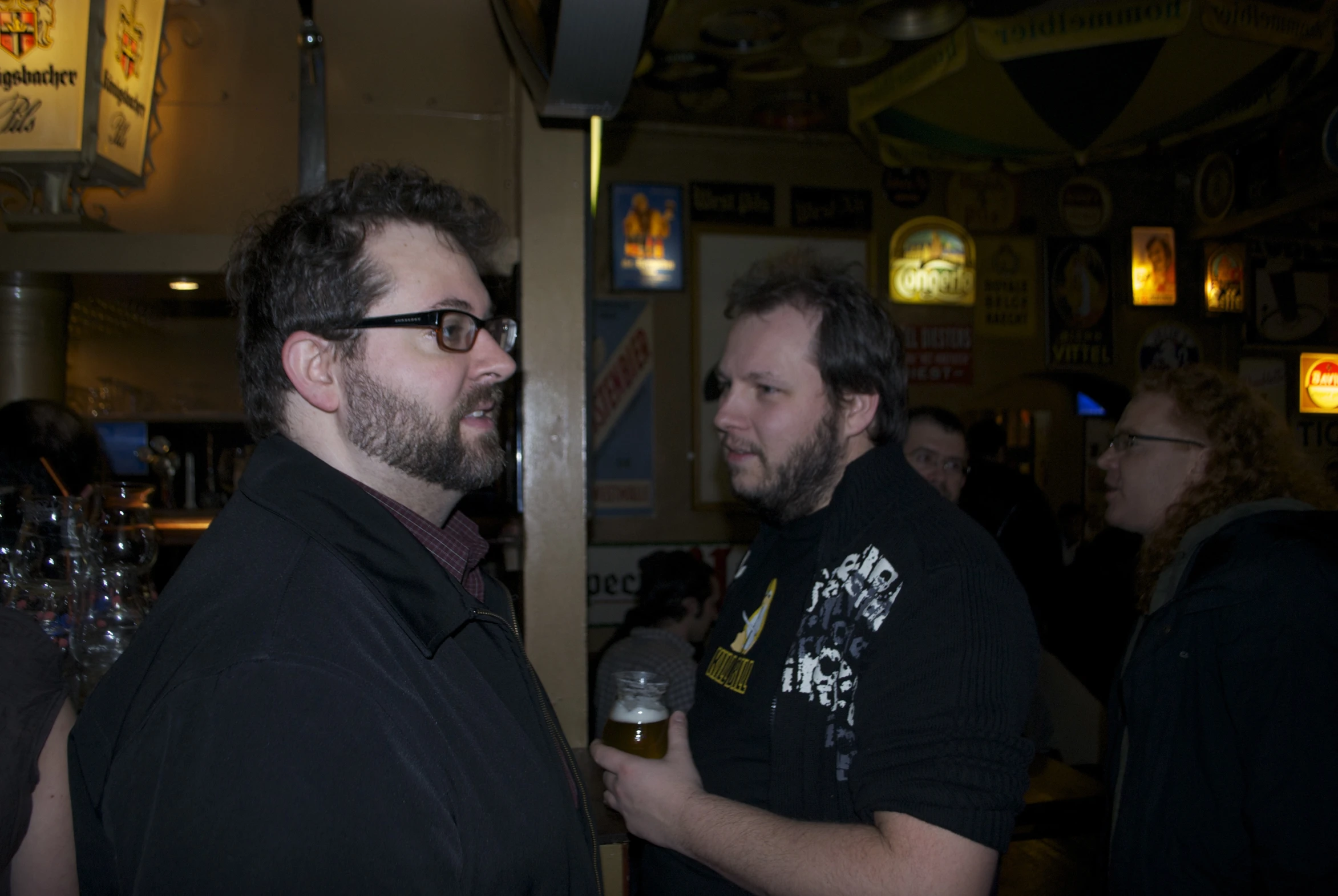 the men are drinking beer together at the bar