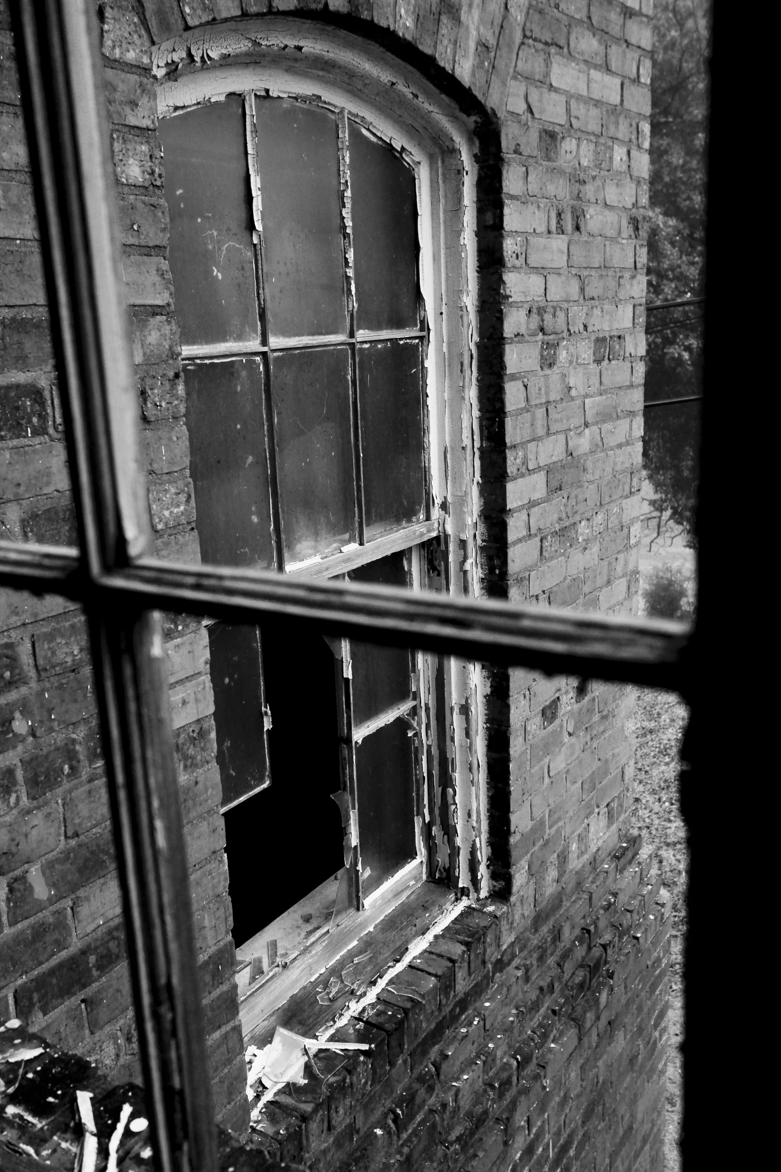 a close up of a brick building with a broken window