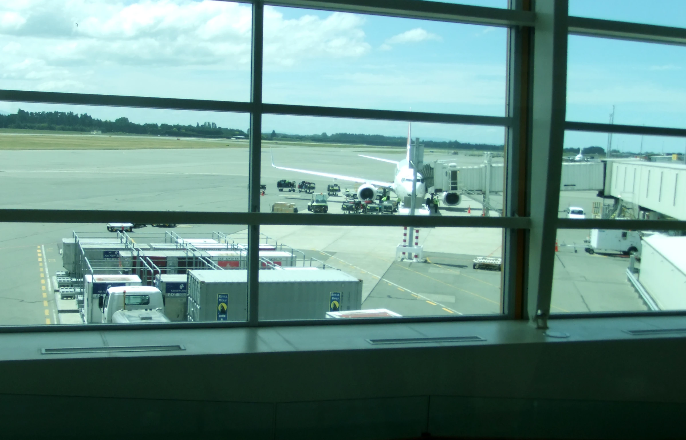 an airport with a plane parked outside the terminal windows