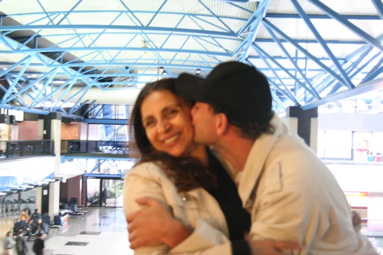 two people hugging each other and posing for a picture