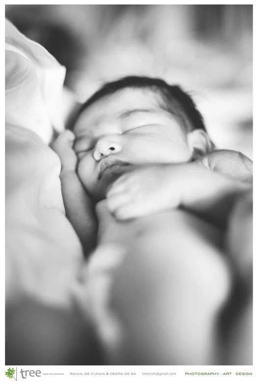 a black and white po of a baby in the bed