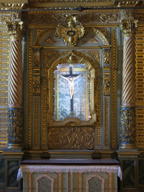 a cross is surrounded by ornate golden walls