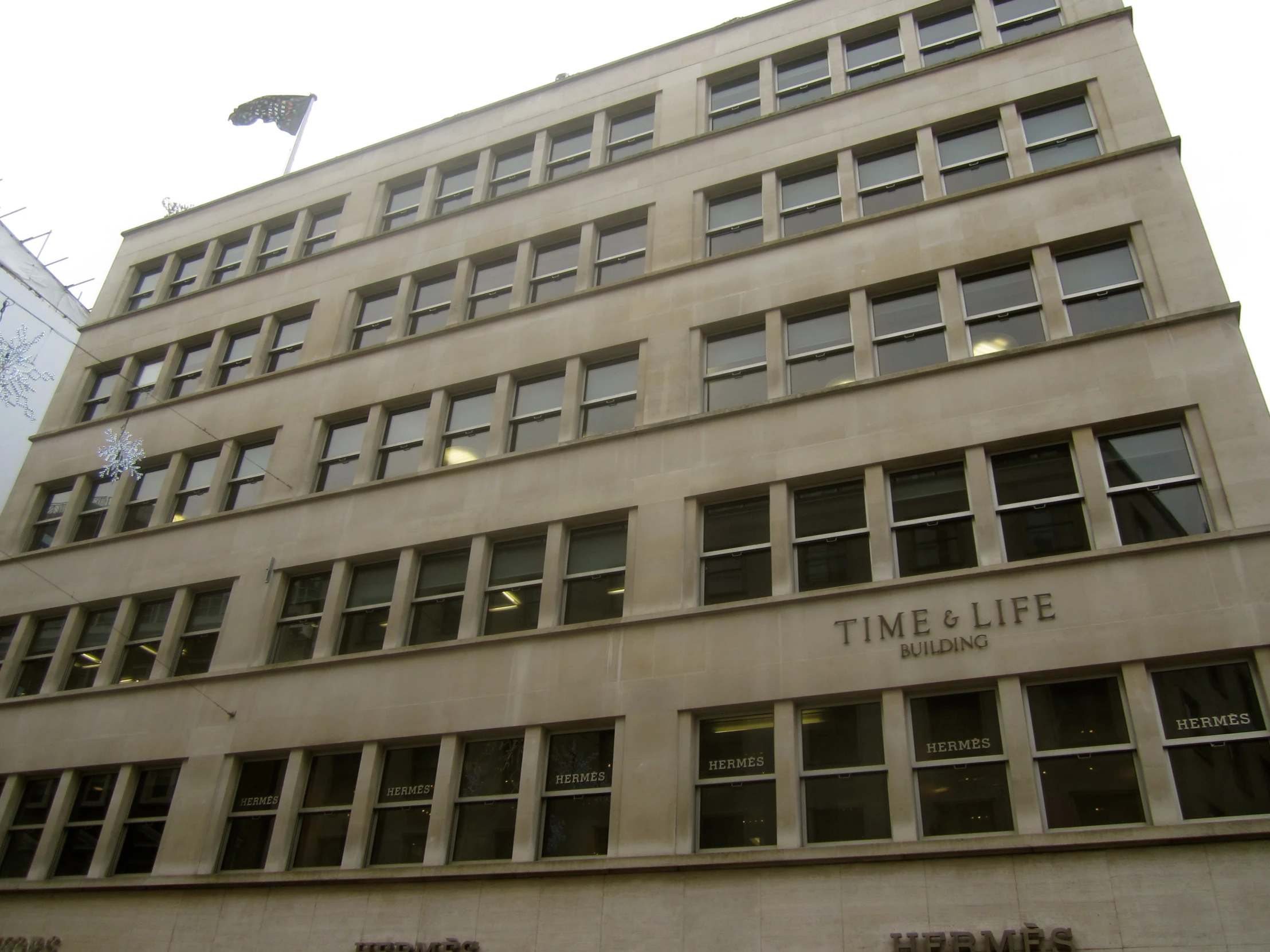 large office building with lots of windows on one side and two floors in the other