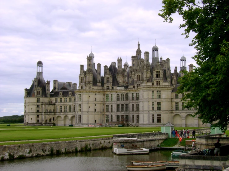 a large castle sitting next to a river