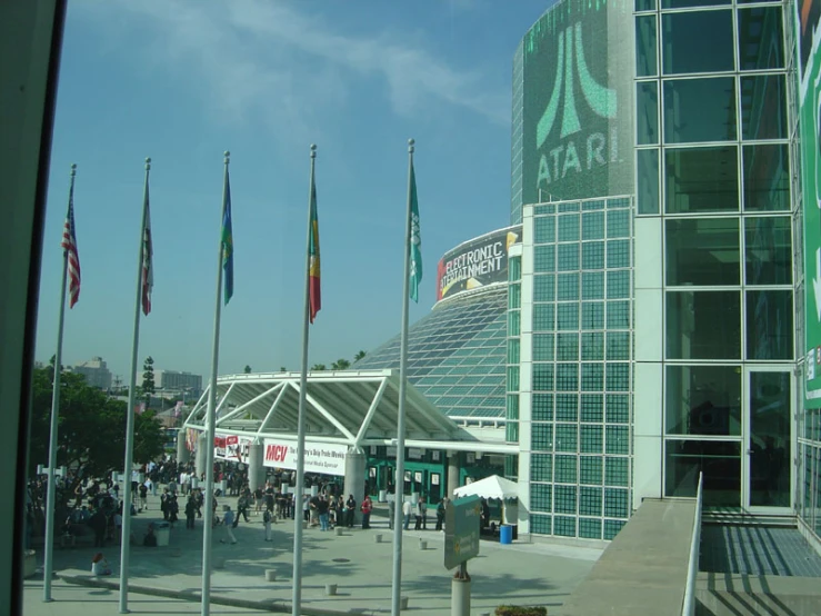 a bunch of flags in front of a large building