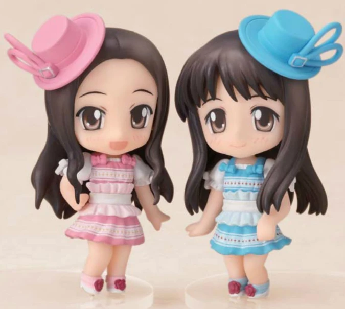 two little girls figurines on display next to each other