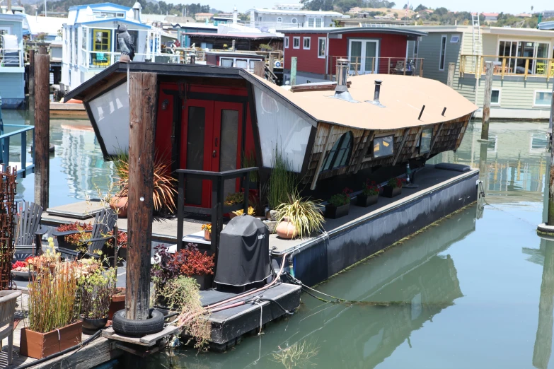 a house boat with plants on the deck