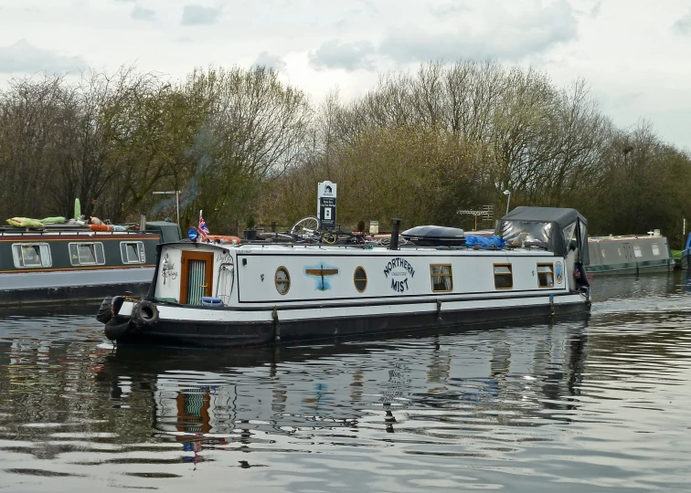 two boats on a river with trees in the background