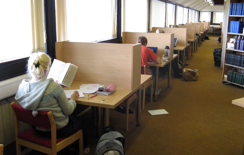 this is an image of some people studying in the liry