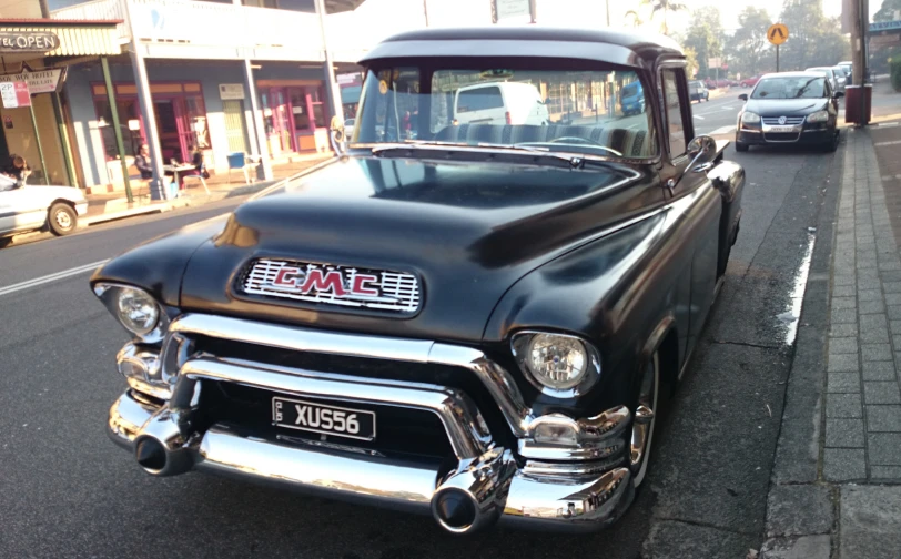 an old fashion pickup truck with custom paint on the front