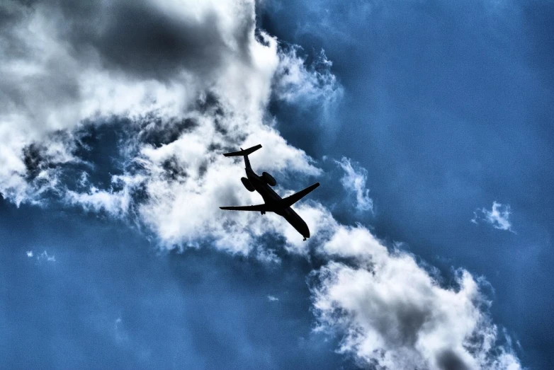 an airplane is flying through a cloudy sky