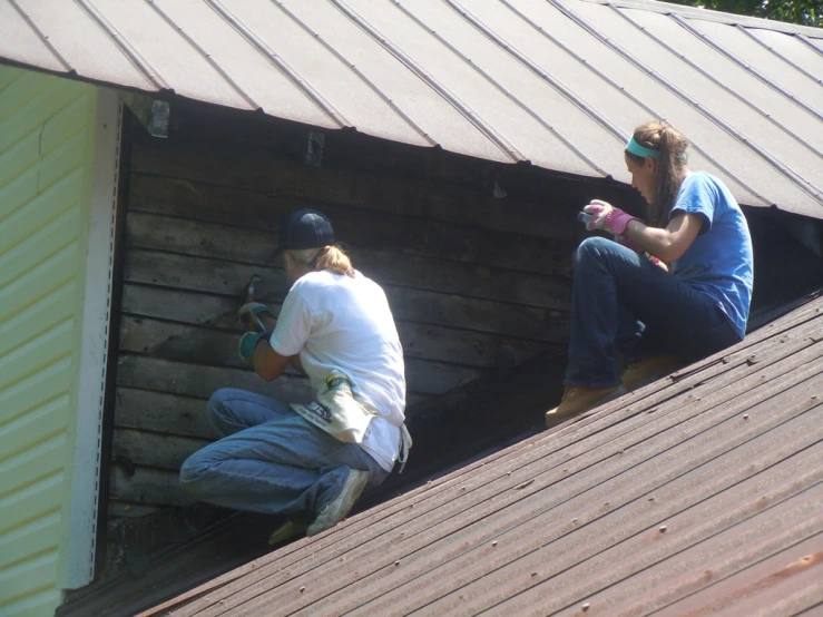 a couple of people standing on top of a roof