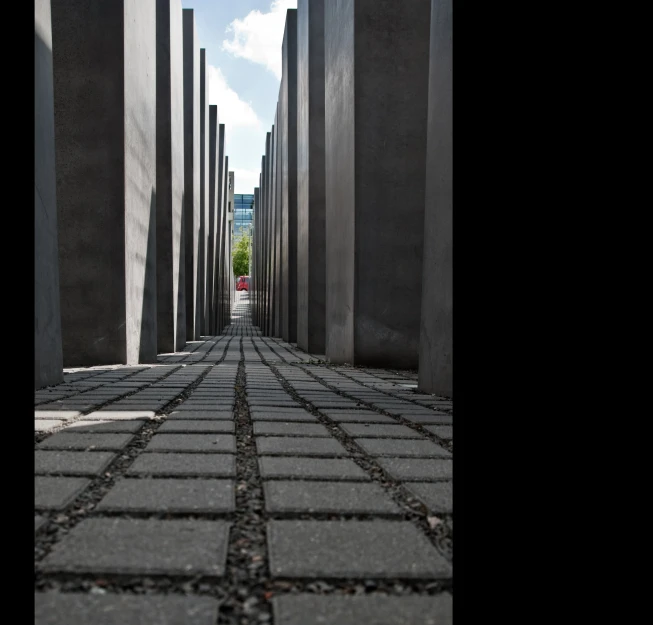 the walkway to the memorial is lined with cement pillars