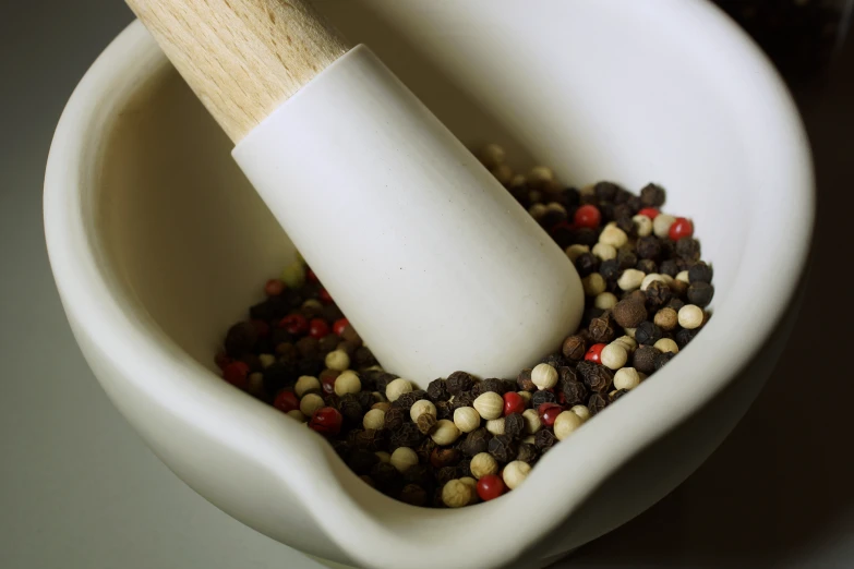 a spoon in a bowl full of brown and red food