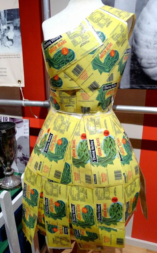 the yellow dress is being displayed on a pedestal